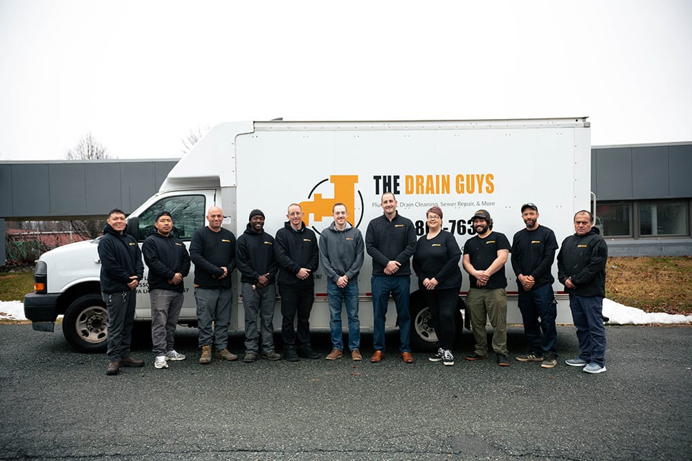 The Drain Guys crew in front of a company truck